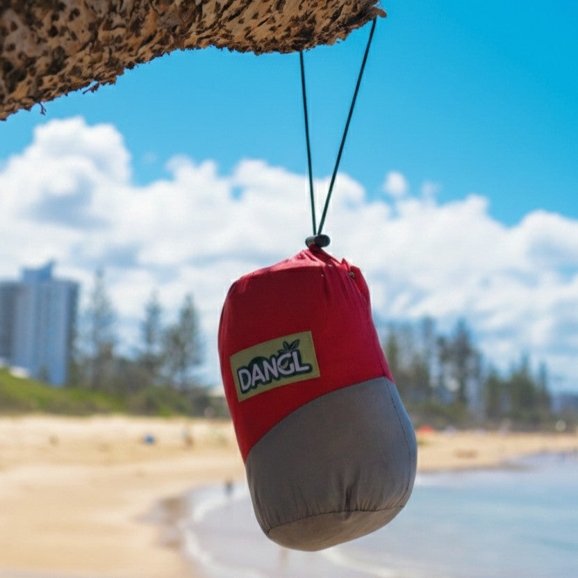 Red DANGL Roamer hanging accessory with a sleek design, showcasing its unique shape and vibrant color.