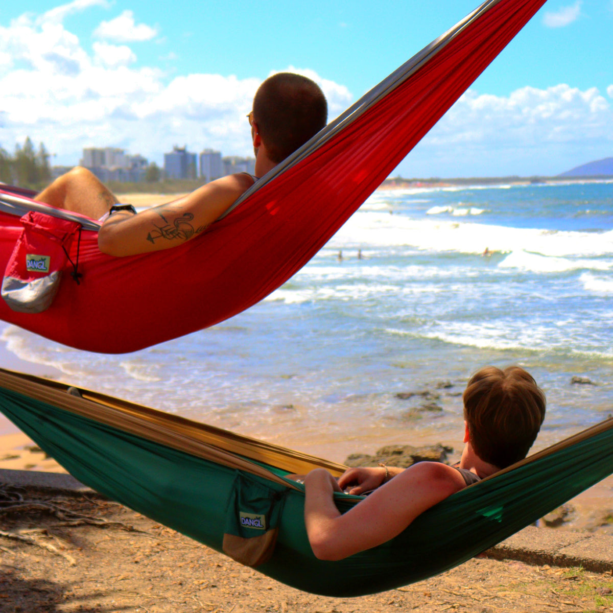 Red DANGL Roamer hanging from a sturdy rope, showcasing its rugged design and vibrant color for outdoor adventure use.